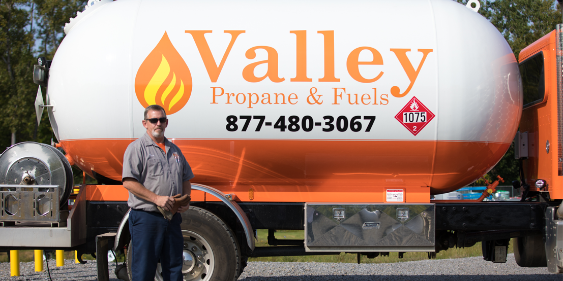 Valley Propane Technician Standing in front of Propane Delivery Truck