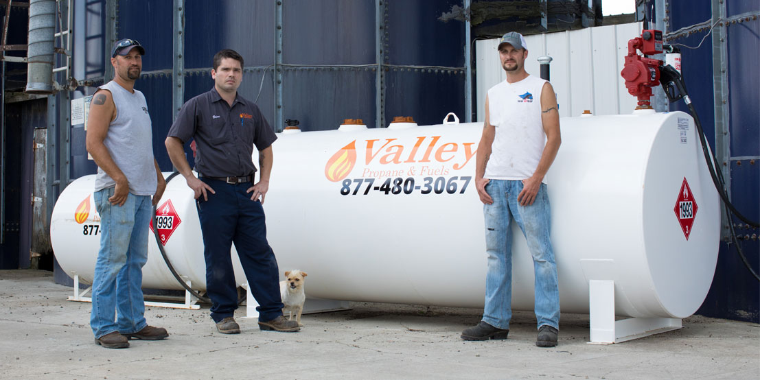 Valley Propane Technicians Standing in front of Commercial Propane Tank